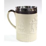 A large cylindrical buff-ground tankard by TURNER, three-pint capacity, with relief decoration of