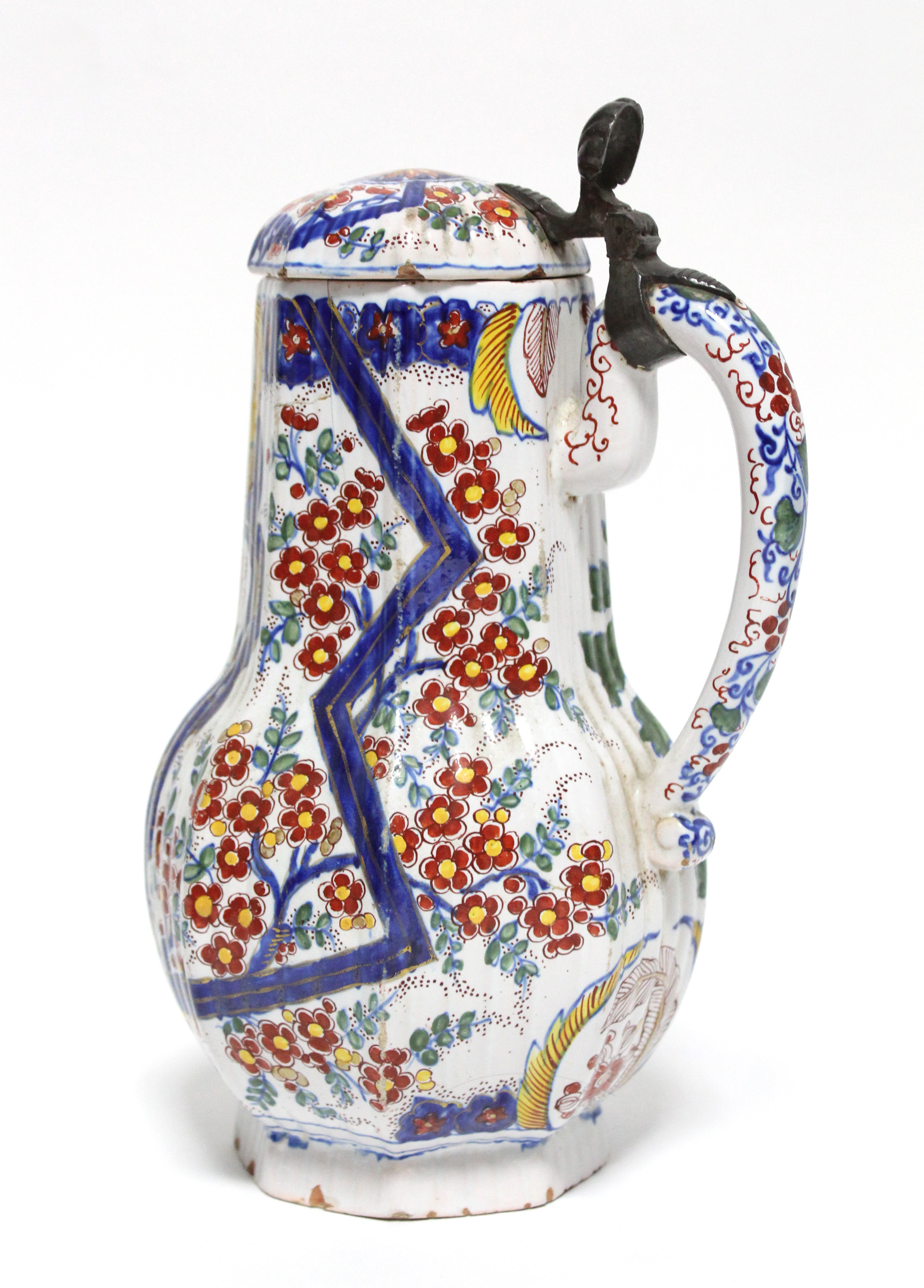 An 18th century Dutch polychrome delft flagon with pewter mounts to the hinged cover, the ribbed