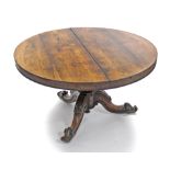 A mid-19th century rosewood centre table, the circular tilt-top on octagonal flared centre