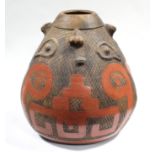 A South American pottery vessel of tapered ovoid form, with carved decoration & iron-red glaze,