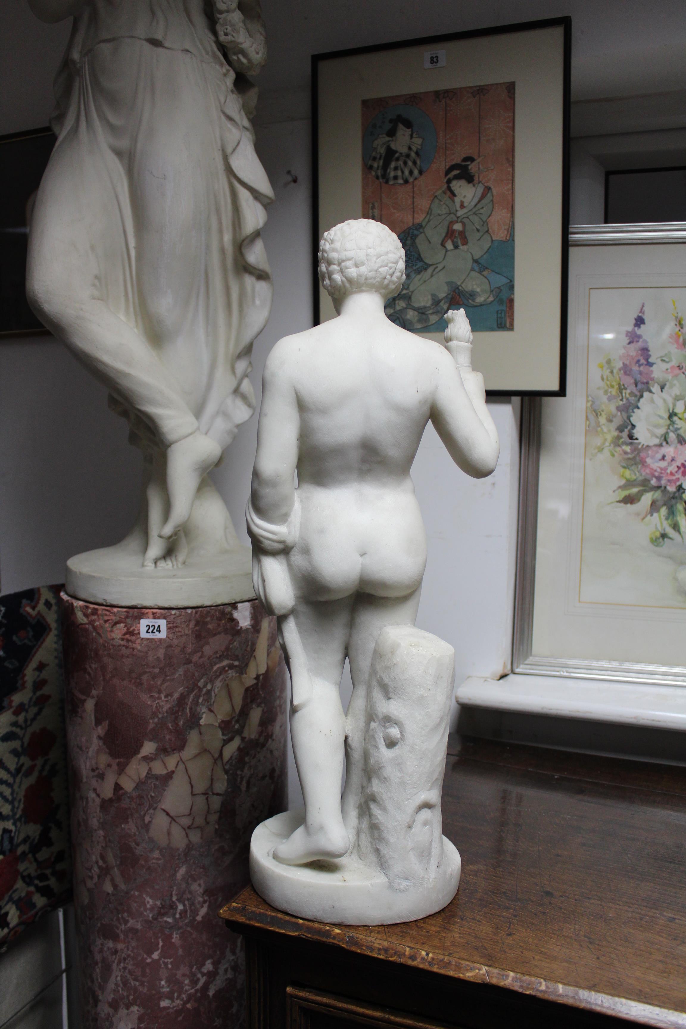 A sculptured white marble standing semi-nude figure of a young man holding a flaming torch in his - Image 6 of 6