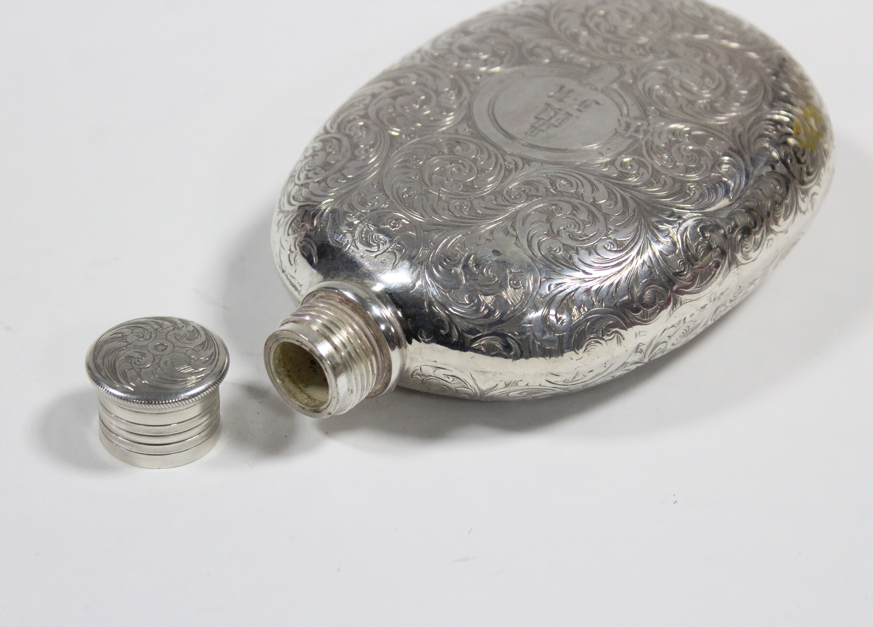 A Victorian silver oval flat-sided pocket spirit flask with all-over engraved decoration of leaf- - Image 3 of 3