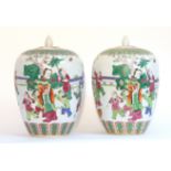 A pair of Chinese porcelain large ovoid vases & covers, decorated in famille verte enamels with