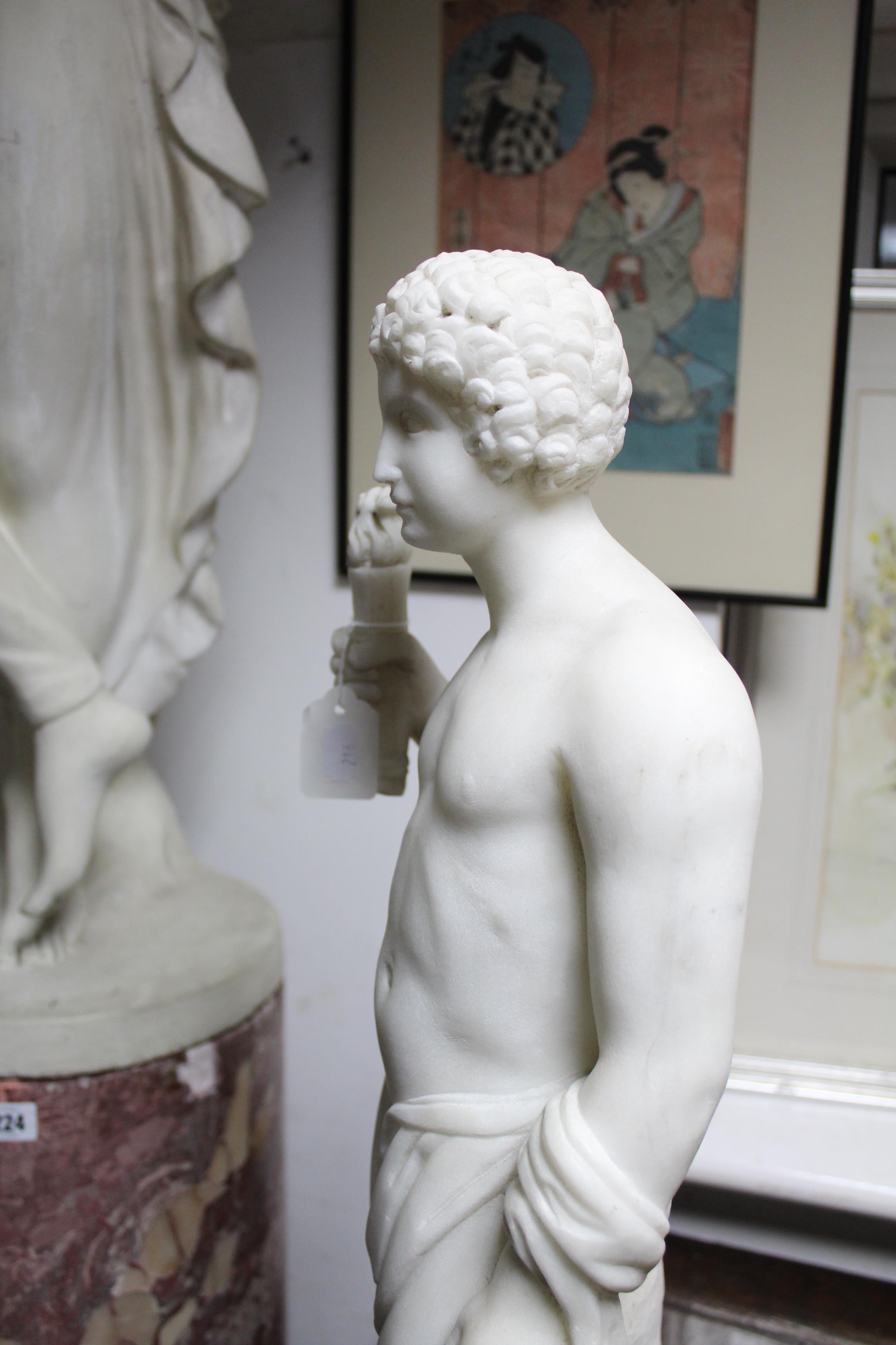 A sculptured white marble standing semi-nude figure of a young man holding a flaming torch in his - Image 4 of 6