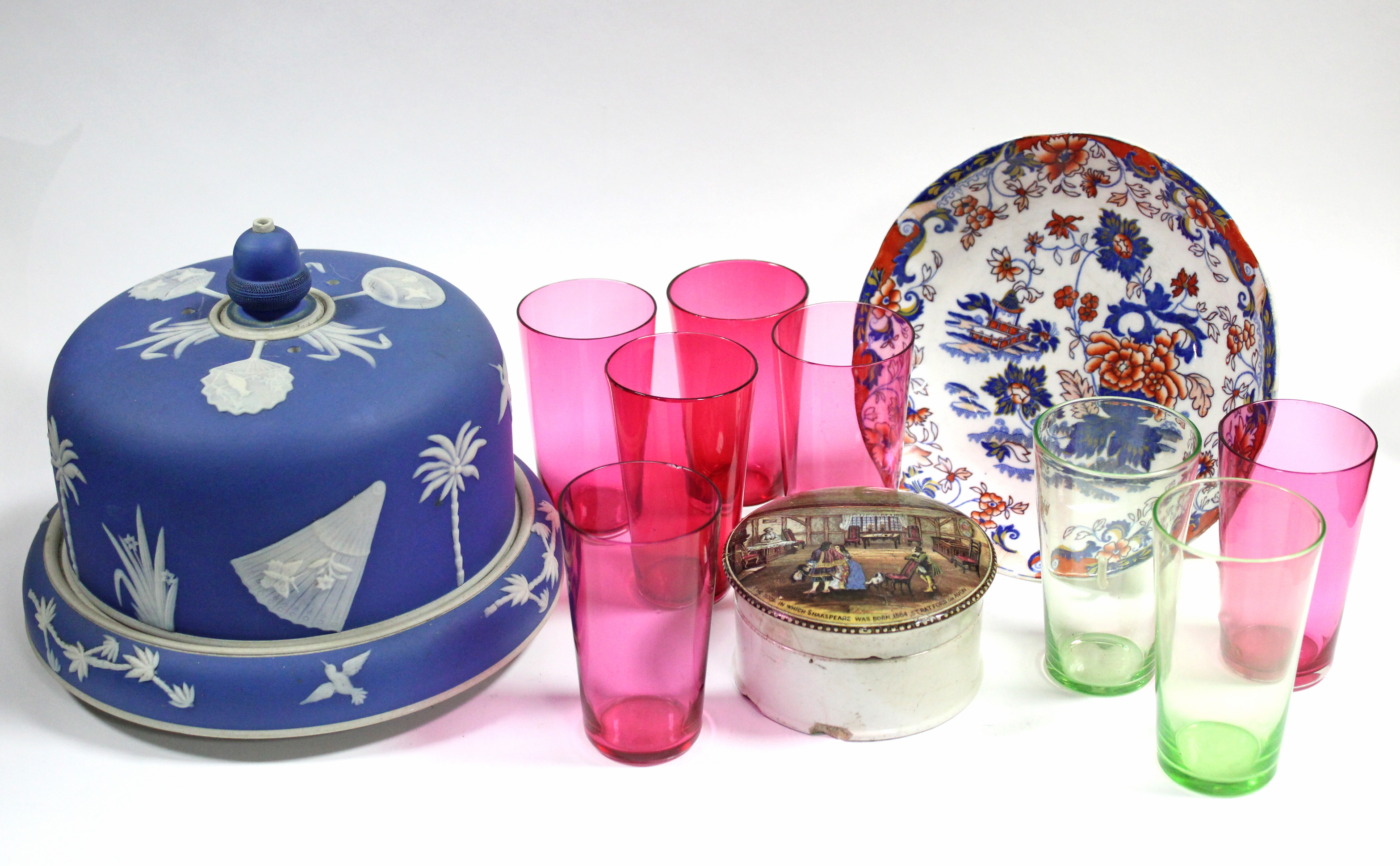 A blue jasper-type stilton dish decorated with face-fans, palm trees, birds, & flowers, the stand