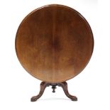 A mid-Victorian mahogany loo table, the circular tilt-top with moulded edge, on turned centre column