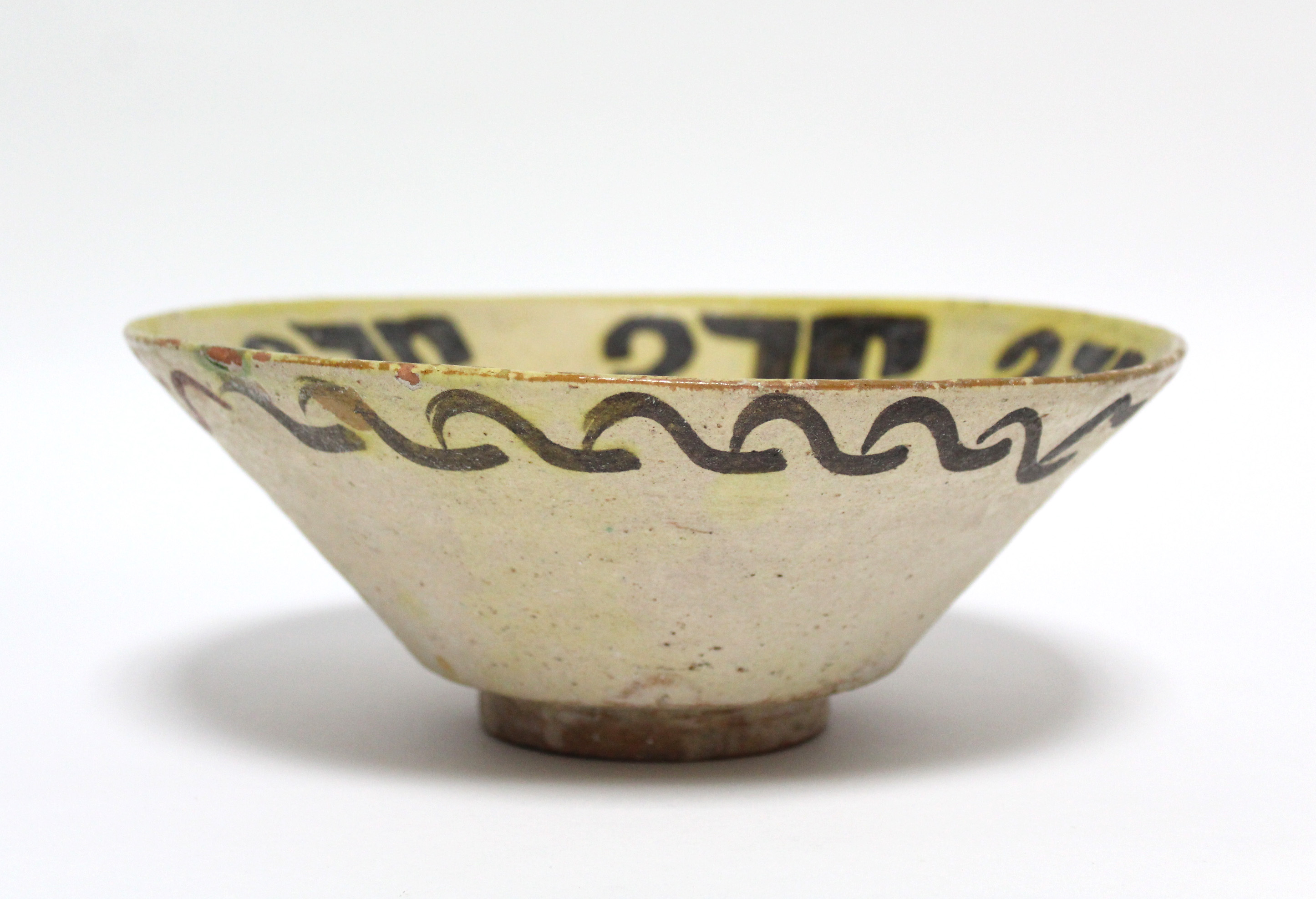 An early Persian pottery deep dish of pale yellow ground, decorated with stylised motifs in - Image 2 of 6