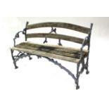 A Victorian Coalbrookdale-type cast iron & wood-slat garden bench formed as oak branches with leaves