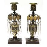 A pair of early 19th century gilt-brass & bronzed candle lustres, each hung with glass drops
