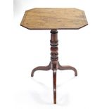 A regency mahogany tripod table, the rectangular tilt top with canted corners, on ring-turned centre