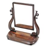 A mid-Victorian mahogany swing toilet mirror, the rectangular plate on carved dolphin supports &