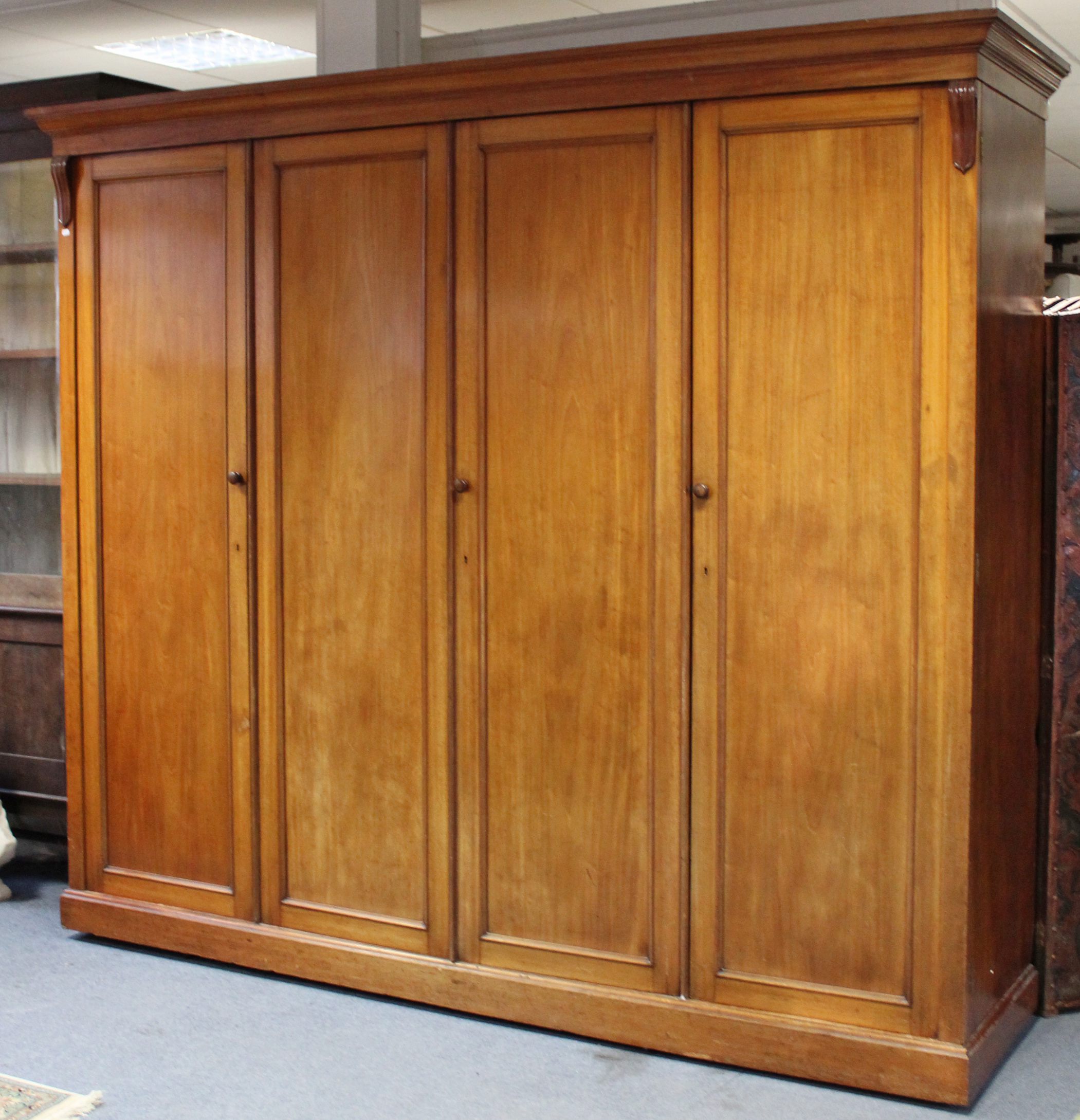 AN EARLY VICTORIAN MAHOGANY WARDROBE, the centre fitted four sliding trays above two short & two