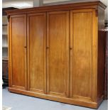 AN EARLY VICTORIAN MAHOGANY WARDROBE, the centre fitted four sliding trays above two short & two
