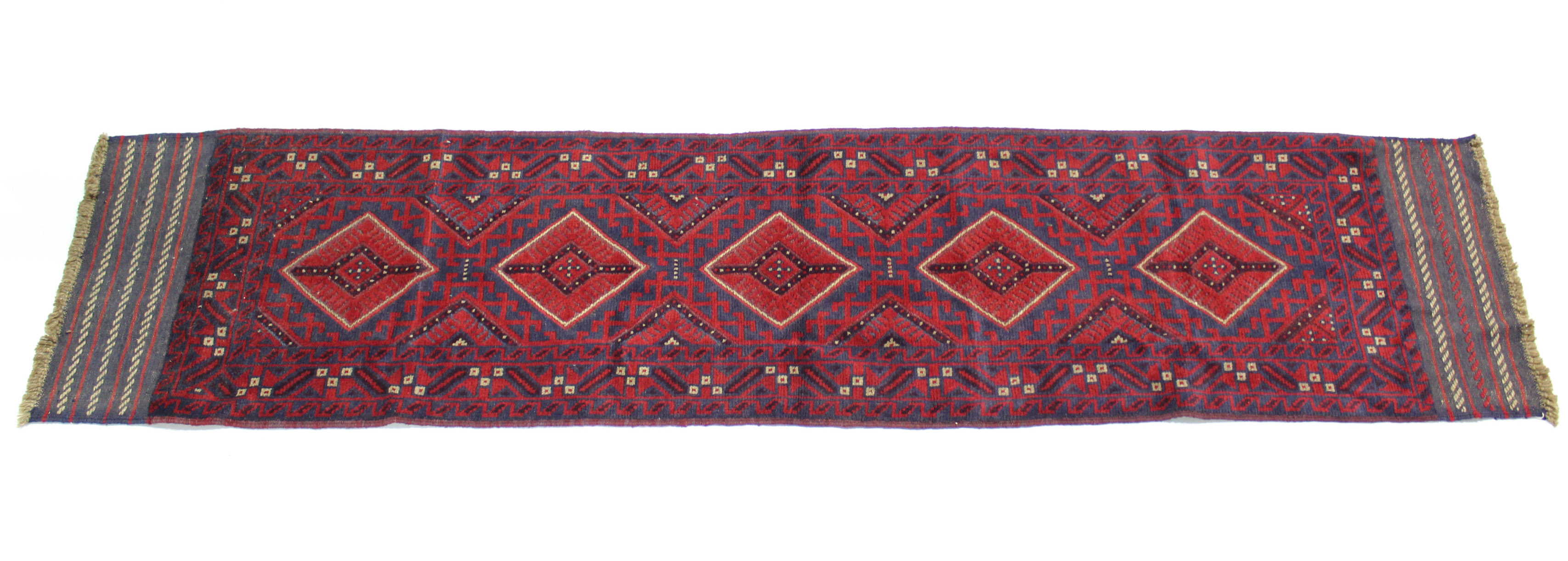 A Meshwari runner of crimson, blue, & ivory ground, with row of five lozenges within geometric