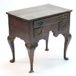 A George III oak lowboy fitted one long & two short drawers above a shaped apron, on cabriole legs