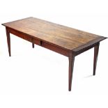 An antique French chestnut dining table, the rectangular top with cleated ends, fitted frieze drawer