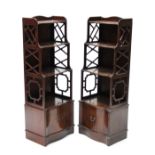 A pair of late 19th/early 20th century American mahogany serpentine-front bookcases in the “