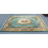 A Chinese carpet of turquoise & ivory ground, with floral & leaf-scroll design in the Aubusson