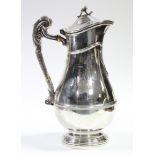 An Edwardian silver wine flagon of baluster shape with applied reeded bands, hinged lid, & reeded