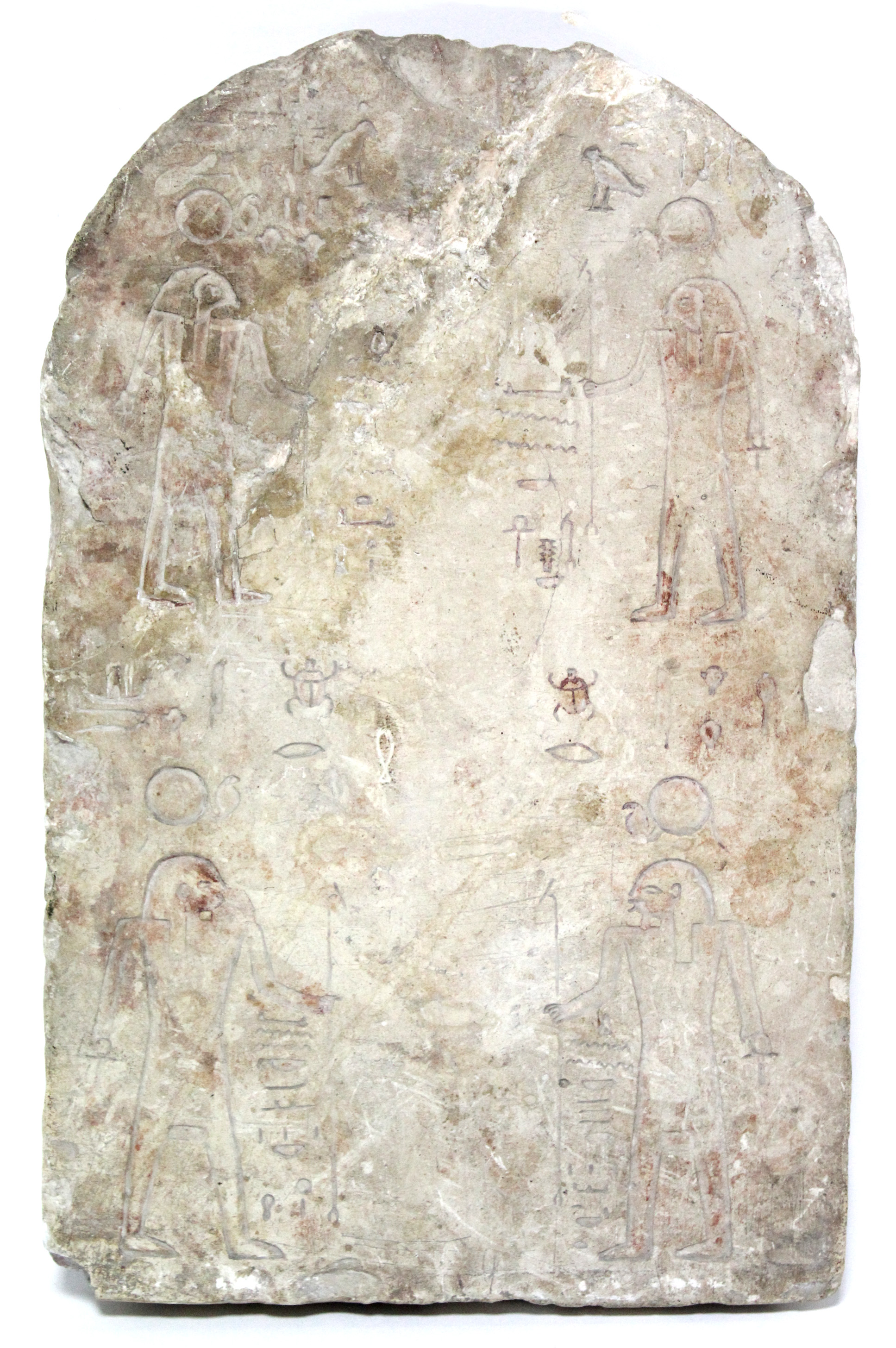 AN EGYPTIAN SANDSTONE STELE with rounded top & carved with hieroglyphs; 13” high x 8¼” wide. (