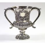 A George IV silver two-handled trophy cup of campana shape, with embossed flowers & foliage, a