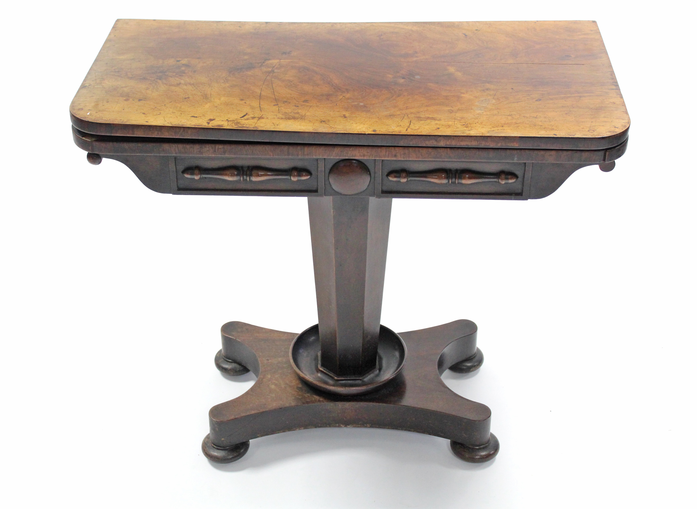 An early Victorian rosewood card table, the rectangular fold-over top with rounded corners, the