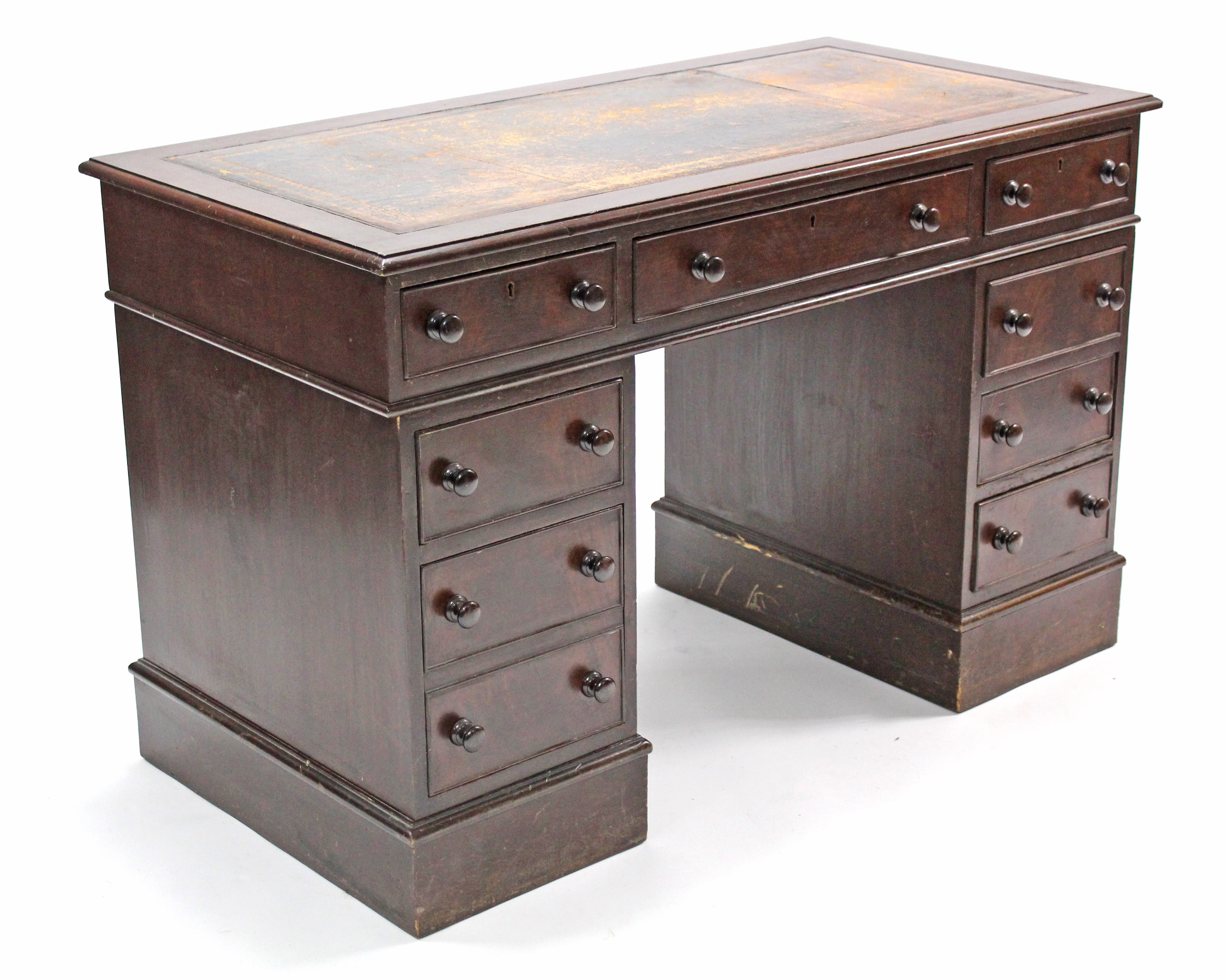 A Victorian mahogany pedestal desk, fitted nine drawers with turned knob handles & inset tooled