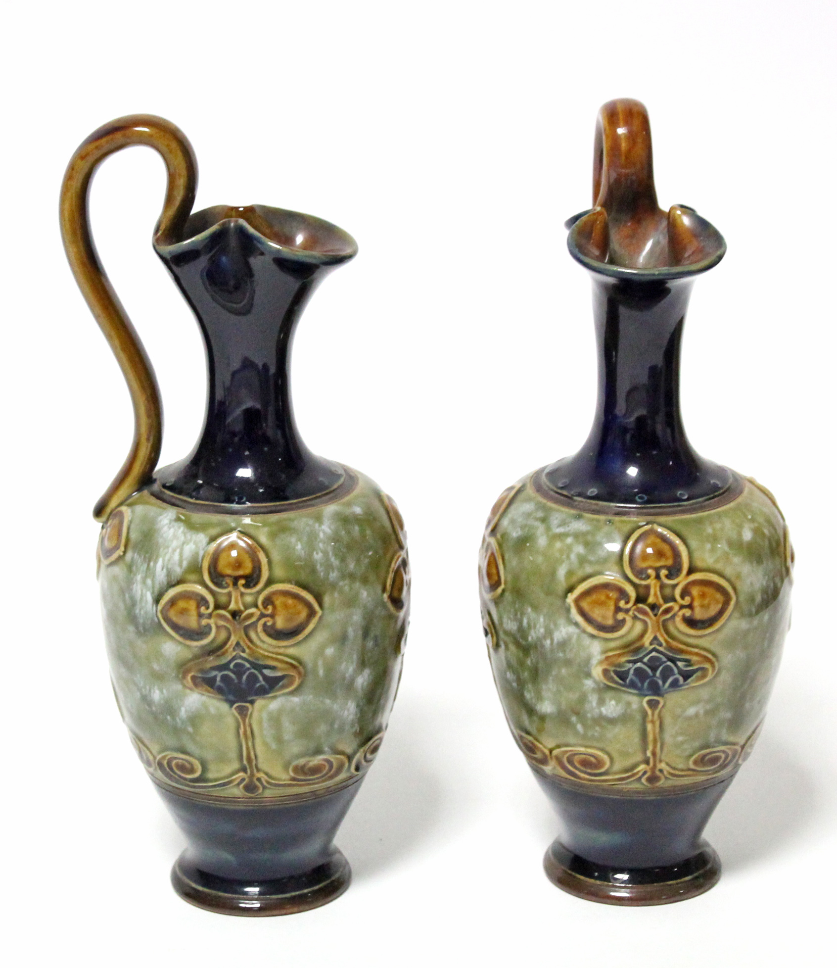 A pair of Royal Doulton stoneware ewers with art nouveau stylised floral motifs; 9½” high. - Image 2 of 3