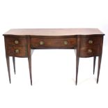 A late 18th century mahogany serpentine front sideboard fitted three drawers,