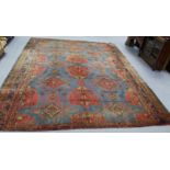 A Turkey carpet of crimson & blue ground with all-over geometric design within multiple borders; 15’