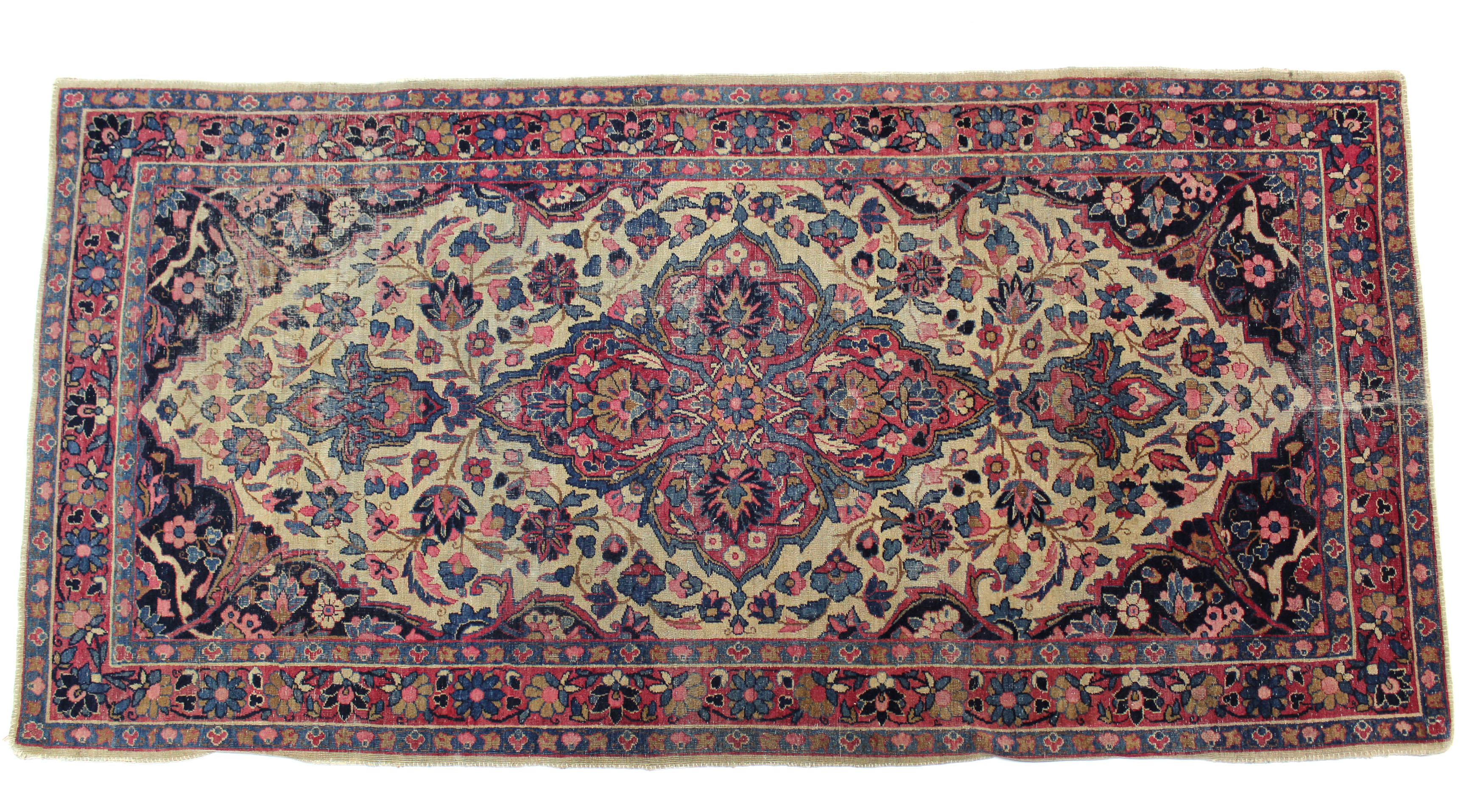 A Persian rug of dark blue ground, with central medallion surrounded by floral spandrels within