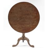 A late 18th century mahogany tripod table, the circular tilt-top on baluster turned centre