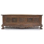 A 19th century INDONESIAN SOLID HARDWOOD CHEST, profusely carved to all sides with floral &