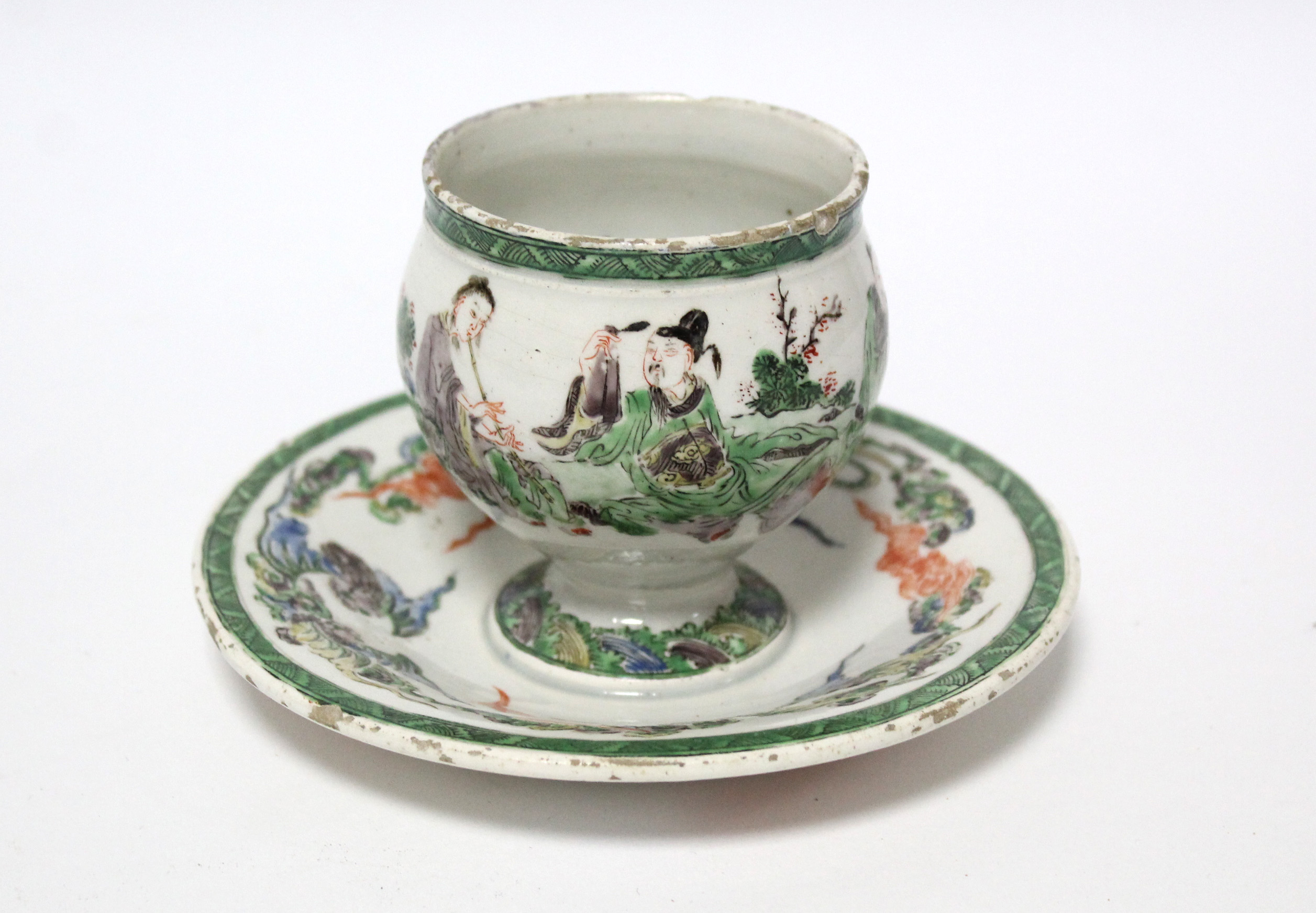 An 18th century English earthenware small round cup on circular integral stand, with finely