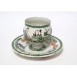 An 18th century English earthenware small round cup on circular integral stand, with finely