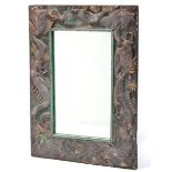 A Balinese rectangular wall mirror in carved frame decorated with mythical sea creatures; 33” x