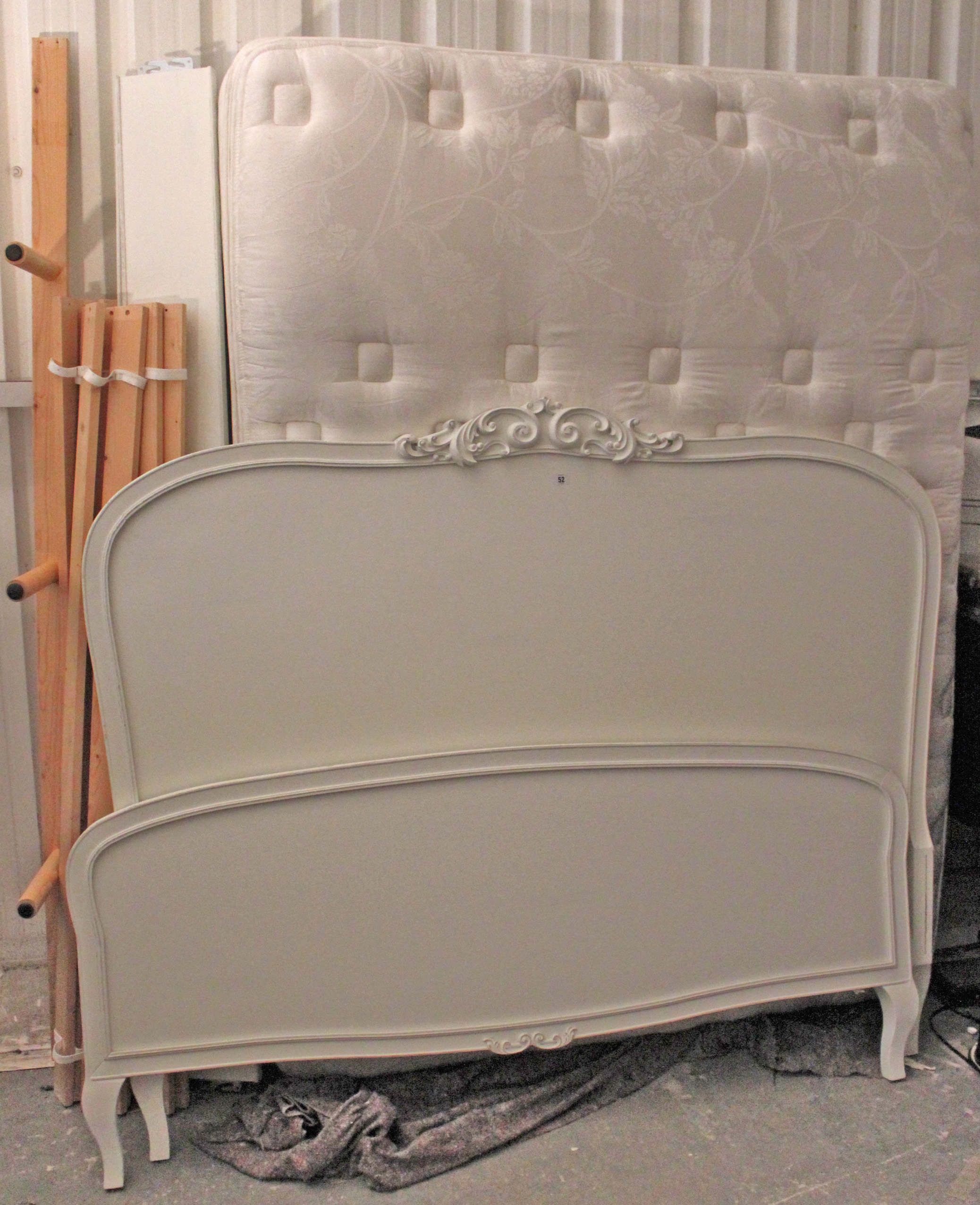 A continental-style white painted wooden 5’ 6” bedstead, complete with mattress.