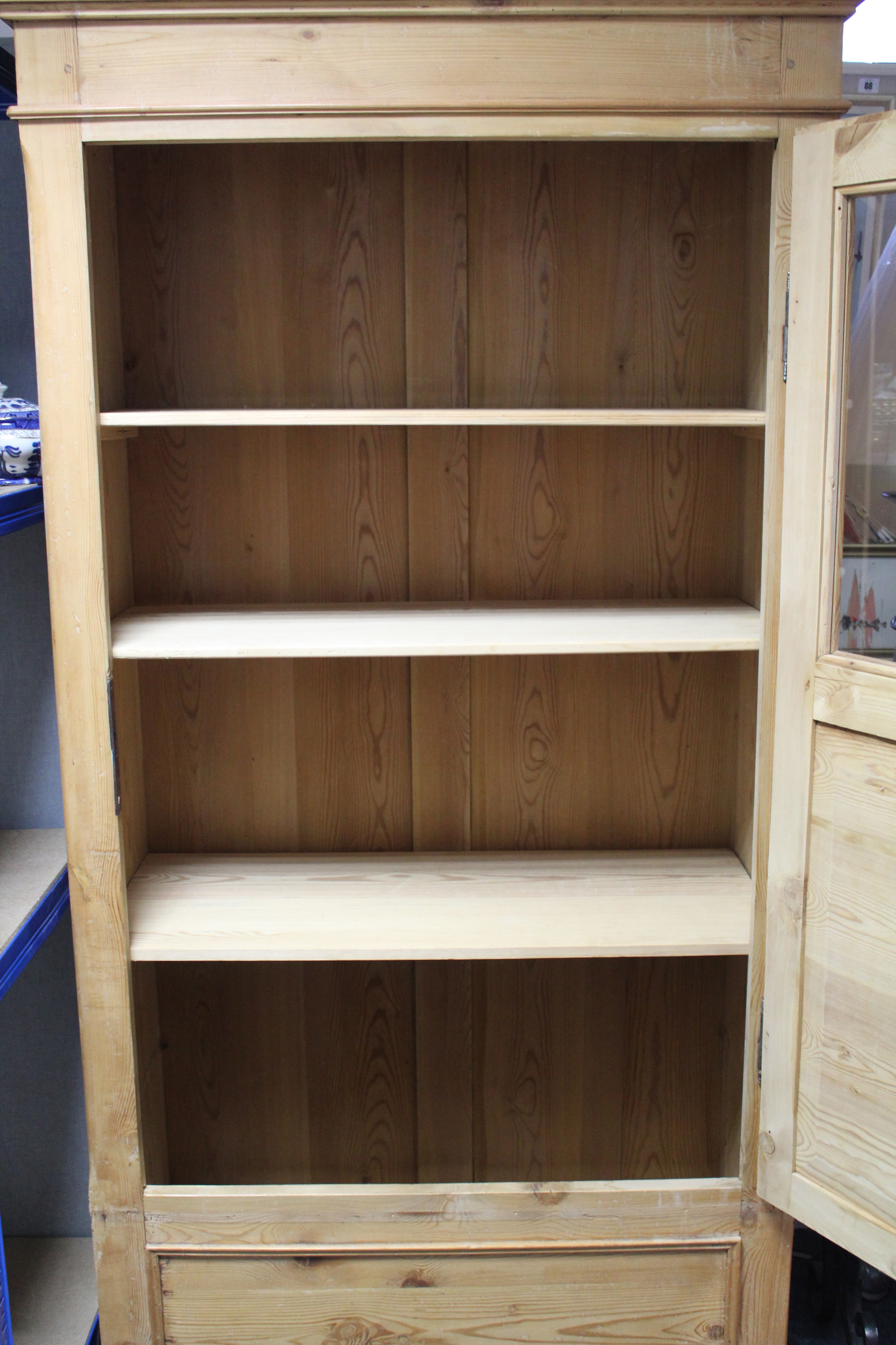 A continental-style tall pine cabinet fitted three shelves enclosed by glazed & panel door, & on bun - Image 2 of 2