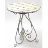 A white painted wrought-metal garden table, on three scroll supports & with white painted wooden