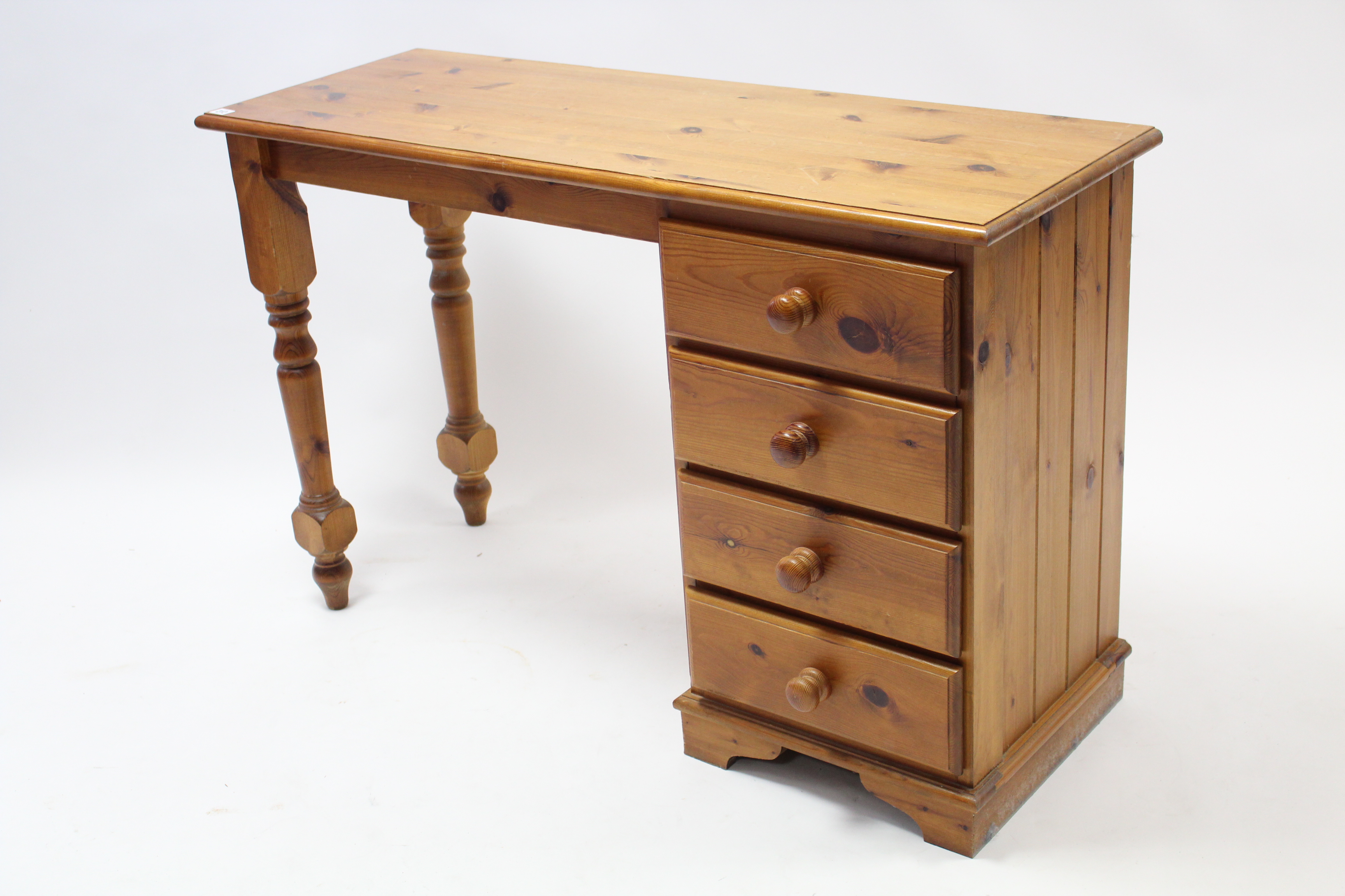 A pine dressing table, fitted four long drawers to the right-hand side, & with turned supports to