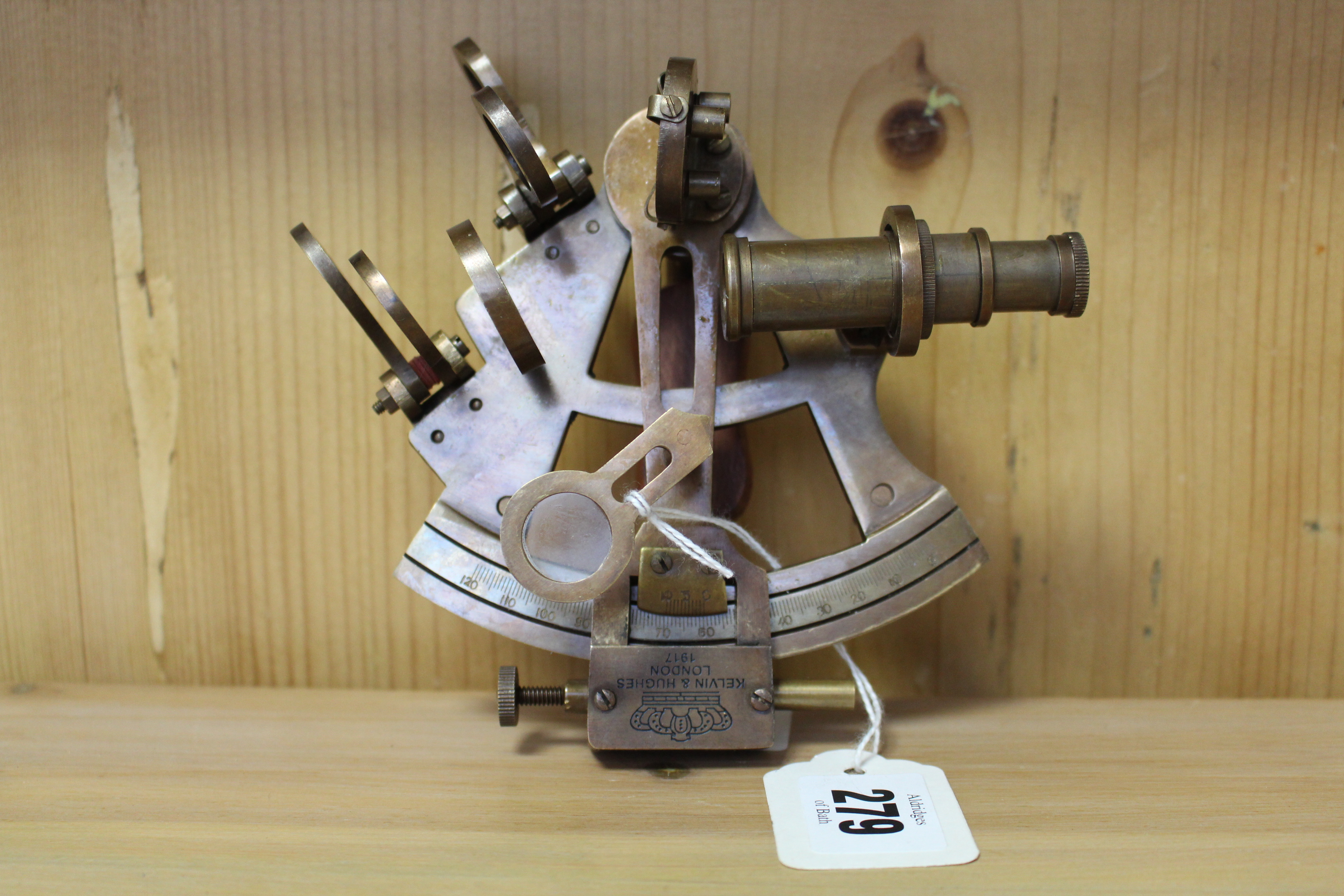 A reproduction brass sextant, 4½” wide.