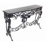 A wrought-iron hall table on scroll legs & with black marble serpentine-front top, 50” long x 31½”