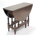 An 18th century oak gate-leg table with oval top, on slender turned supports with plain