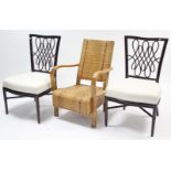 A teak frame easy chair with woven rattan seat, back, & sides, & a pair of cane dining chairs.