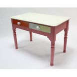 A multicoloured painted pine child’s side table, fitted frieze drawer, & on turned legs, 36” wide