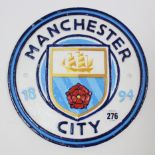 A modern painted cast-iron circular sign “MANCHESTER CITY 1894”, 9½” diam.