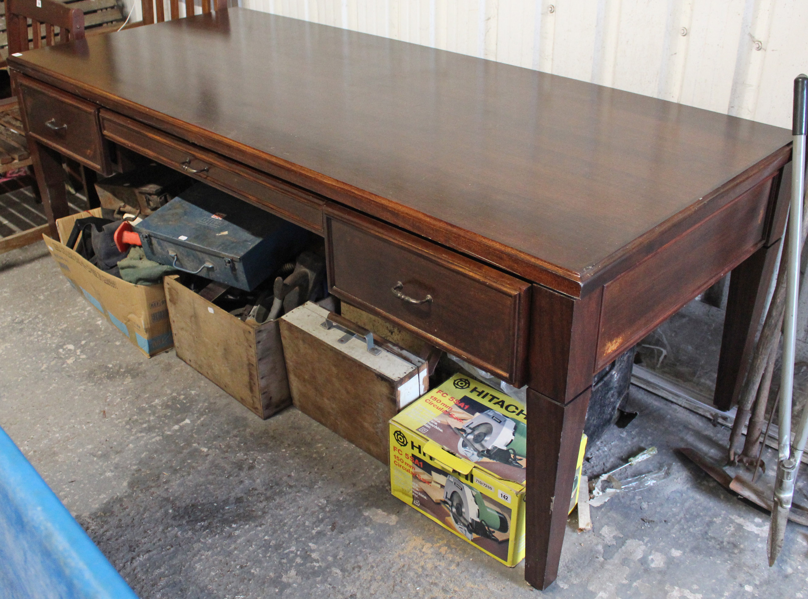 A mahogany-finish large kneehole writing table with moulded edge to the rectangular top, fitted