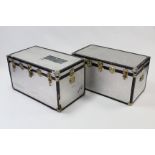 A pair of silvered-finish travelling trunks with hinged lift-lids & brass fittings (slight