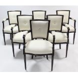 A set of six French-style ebonised frame elbow chairs, with padded backs & sprung seats, & on fluted