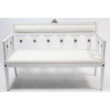 A continental-style white painted wooden two seater settee with gilt ormolu decoration to the